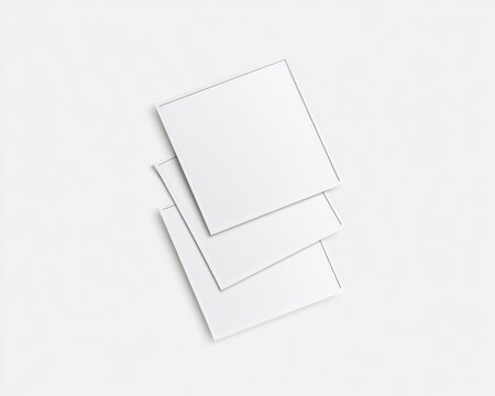 Three blank square paper sheets stacked on a white background