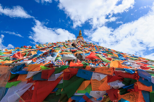 The Changqing Chunker Temple  in Litang, China. Many colourful prayer flags on the mountain top beside the temple.Spirituality and meditation.