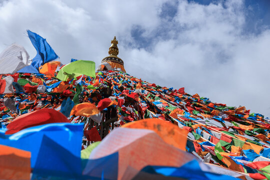 The Changqing Chunker Temple  in Litang, China. Many colourful prayer flags on the mountain top beside the temple.Spirituality and meditation.