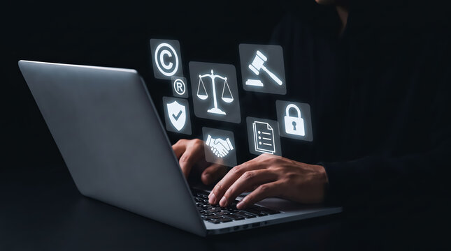 Person using a laptop with glowing legal and compliance icons floating above