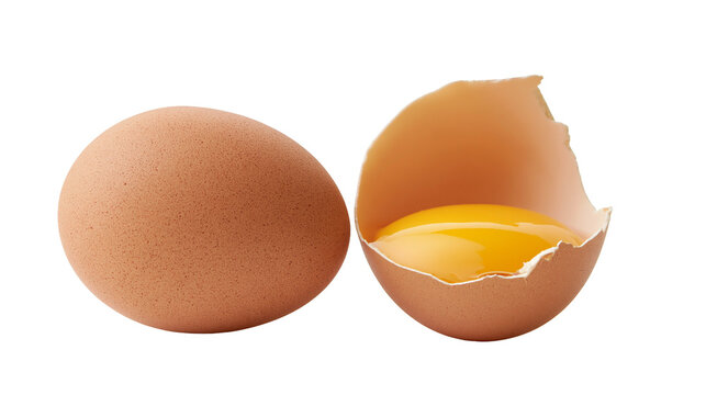 Whole brown chicken egg and broken eggshell with raw yolk