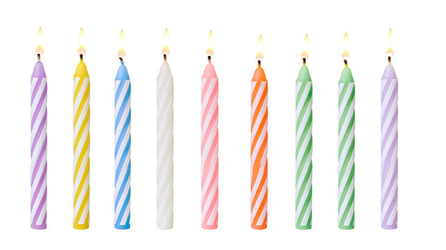 Row of colorful striped birthday candles with lit flames