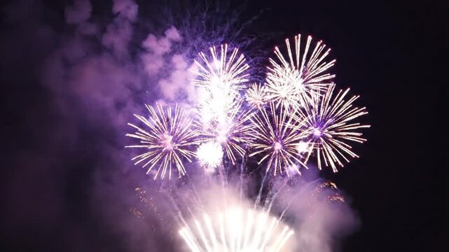 Red and white fireworks exploding in night sky with smoke