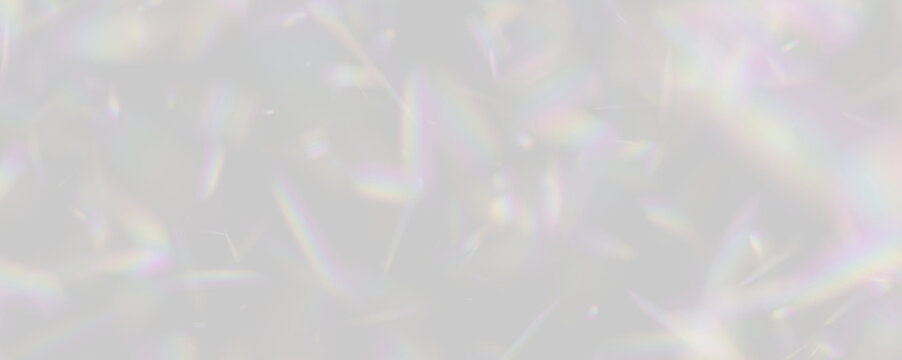 A scatter of rainbow-hued prism light fragments floats against a deep black backdrop. These multicolored shards exhibit a soft, blurred dispersion effect.