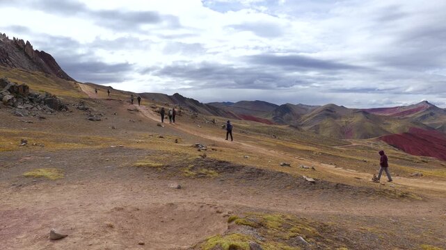 Tourists walk to the Rainbow Mountains viewpoint at Palcoyo in Peru.