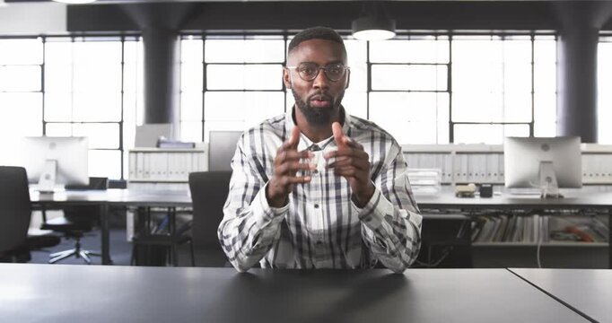 Close up of people talking to the camera, businessman in office, explaining while sitting at desk