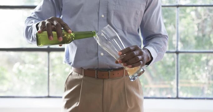 Lifestyle videos indoor of people doing activities at office, pouring beer from bottle into glass, m