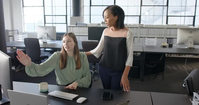 Lifestyle videos indoor of people doing activities at office, collaborating in office, two women dis