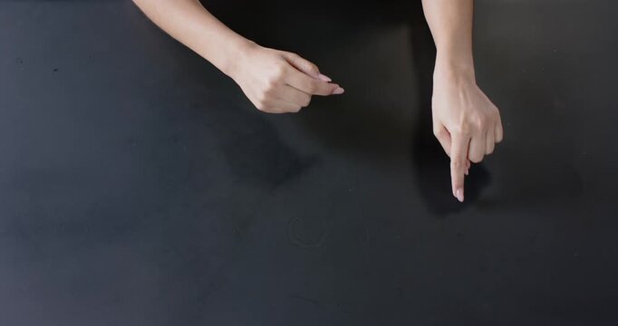 Close up of people talking to the camera, pointing at black surface, person using hand gestures for