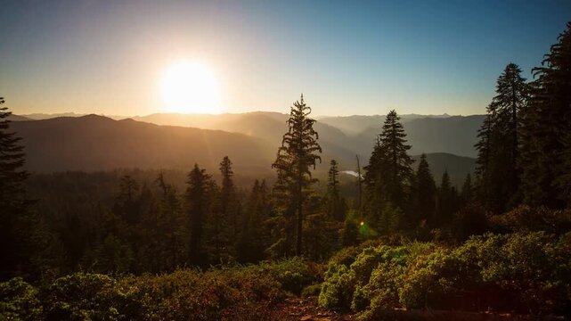 Tropical forest nature landscape with mountain range sunrise time lapse with moving cloud mist, 4K time lapse. Bright sunset in Smoky Mountains summer. green woods trees in summertime season. Beauty