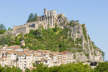 Fototapeta premium The citadel of Sisteron on its rock above the town, seen from the shore of the Durance river