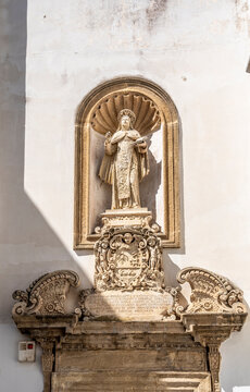 Statue of Saint Teresa in a niche above the Baroque Church of Santa Teresa in the historic center of Gallipoli, Salento, Puglia, Italy.