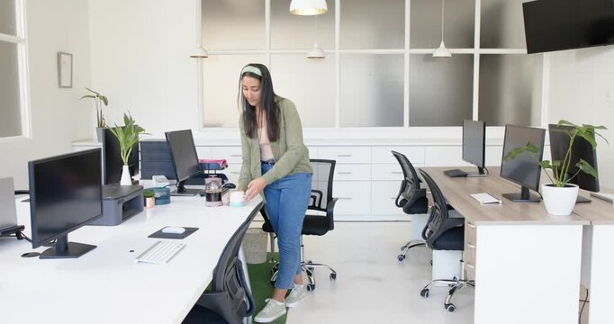 Lifestyle videos indoor of people doing activities at office, woman standing in modern office with c