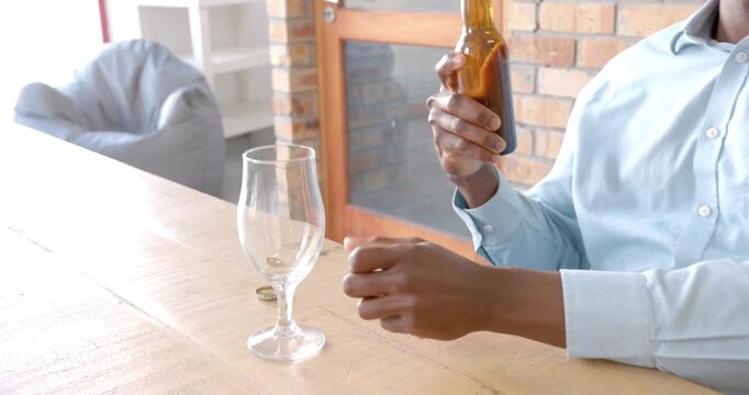 Lifestyle videos indoor of people doing activities at office, pouring beer from bottle into glass, m