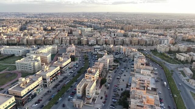 Pulling Back Aerial Wide Shot of Residential Cityscape and Traffic in Cairo, Egypt during Sunset