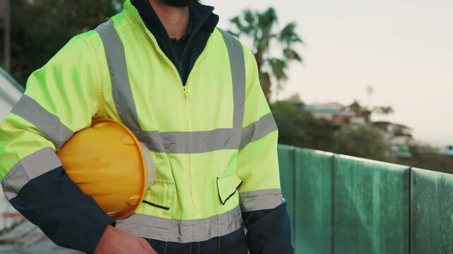 Man, hands and worker at construction site with helmet, remodeling project or safety rule compliance. Builder, person and PPE on balcony outdoor for injury prevention, infrastructure and engineering.