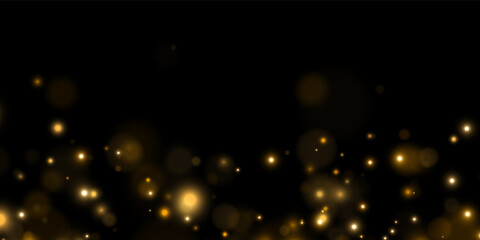 Scattered golden bokeh lights glow softly against a deep black backdrop. The lights vary in size and intensity creating a warm and dreamy atmosphere. This effect is perfect for festive. © megasuperman