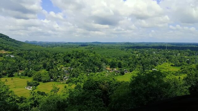 Vast green valley landscape under cloudy blue sky panoramic scenic view outdoor