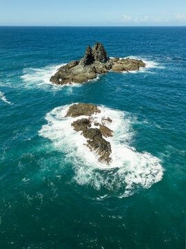 Wild Reef Outcrop Rising from Churning Turquoise Ocean Waves