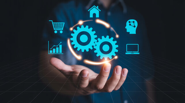 Businessman holding two glowing gears representing automation and digital transformation.