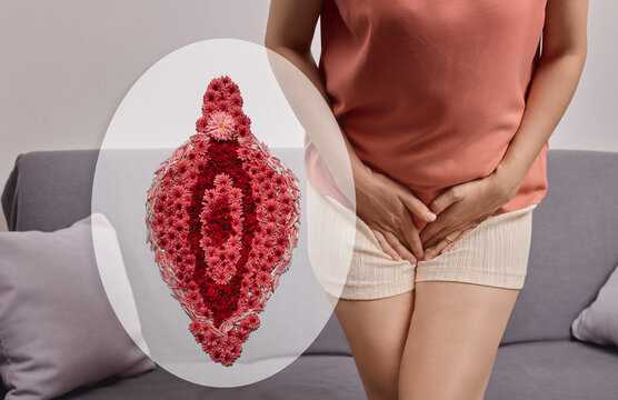 Woman sitting on a sofa holding her pelvic area next to a floral vulva illustration. Female intimate flora balance and reproductive wellness concept
