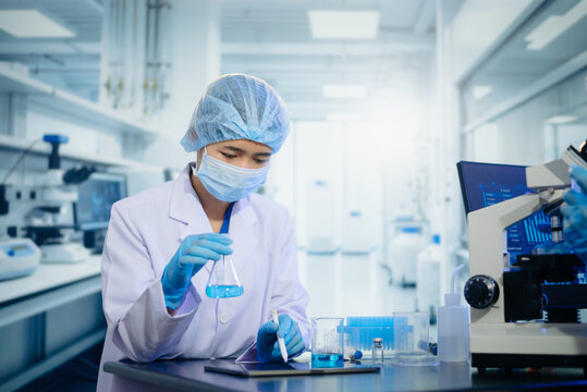 Scientists in lab coats collaborating with test tubes, flasks, and microscopes