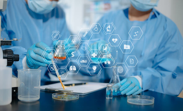 Medical researchers using pipettes, flasks, and advanced futuristic digital HUD graphics in laboratory research facility.