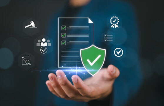 Hand holding a document icon showing successful compliance and quality assurance. concept represents risk management, legal policy, and data protection in modern corporate technology.