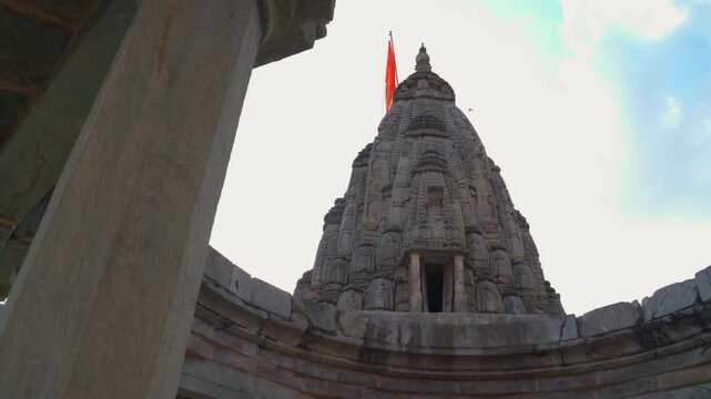 Low angle wide shot of the intricately carved stone shikhara tower at Jagat Shiromani Temple in Amer, Jaipur, Rajasthan, India.