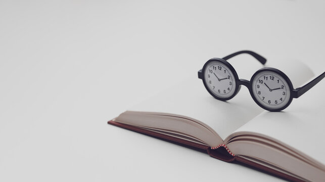 Taking Time to Read with an Open Book and Clock Glasses