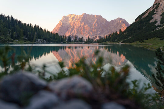 Reflecting Wetterstein Mountains in Warm Evening Light at Sunset. Seebensee, Austria