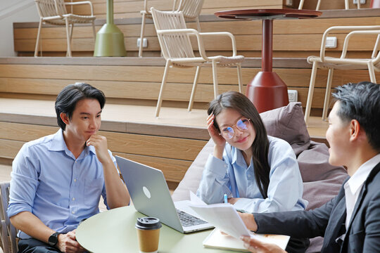 Young Professionals Collaborating on Project in Modern Coworking Space