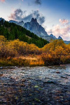 Rocky Mountain Peak over River Flowing Surrounded by Larch Forest in Claree Valley French Alps Nevache France