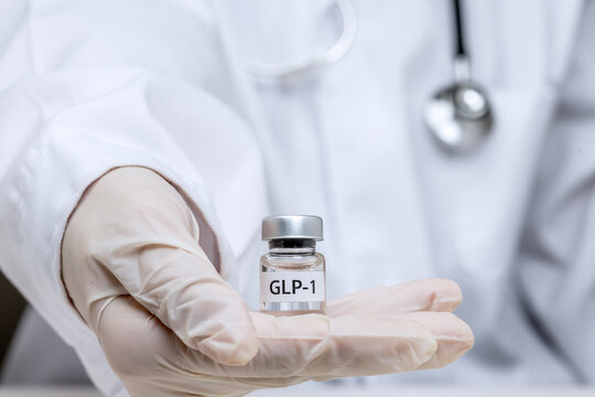 Confident doctor hand holding small vial presents medical weight management treatment with hopeful care for effective healthcare therapy