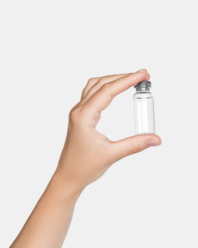Hand Holding Small Glass Vial