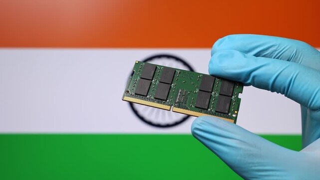 Close up view of hand in blue glove holding RAM memory microchip module. Indian flag in blurred background. Concept of semiconductor shortage and artificial intelligence development in India.