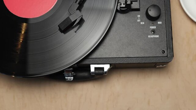 Vintage record player with coffee cup on wooden table