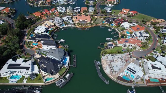 Aerial view of modern waterfront luxury residential real estate development in Australia.