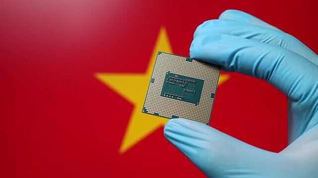 Close up view of hand in blue glove holding CPU microchip. Vietnamese flag in blurred background. Concept of semiconductor shortage and artificial intelligence development in Vietnam.