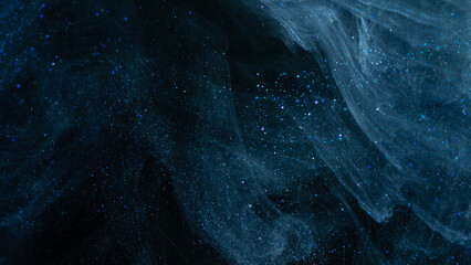 Abstract dark blue smoke cloud over black background with scattered luminous particles © ossyffer