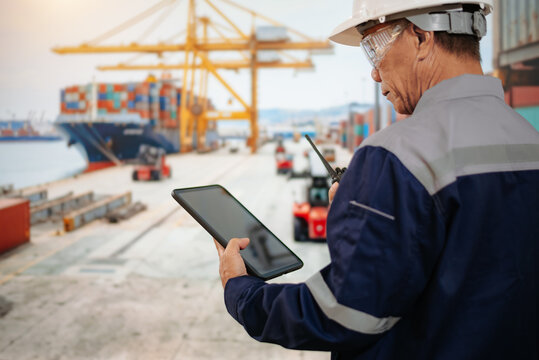 Logistics engineer oversees shipping operations at a container terminal