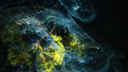Yellow flower submerged in swirling blue ink clouds against black background, with flower, yellow, ink, swirl detail © ossyffer