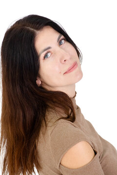 Portrait of a beautiful brunette woman with long hair looking back over her shoulder on white