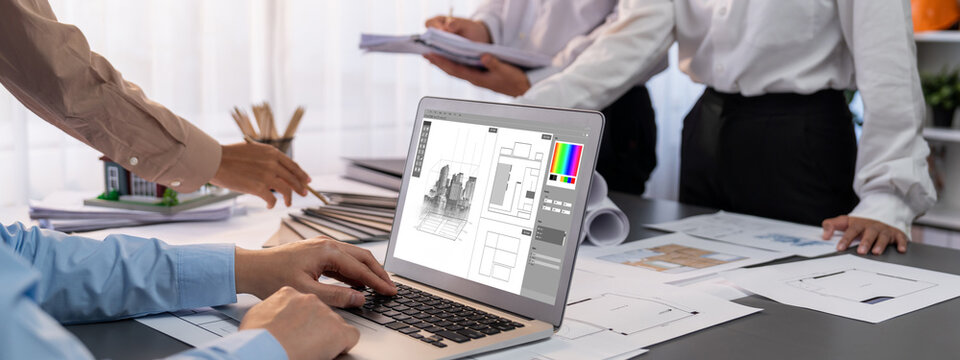 Group of interior architect designer discussing together on blueprint and laptop screen display architecture software for more precise designing layout. Modern home design and renovation. Insight