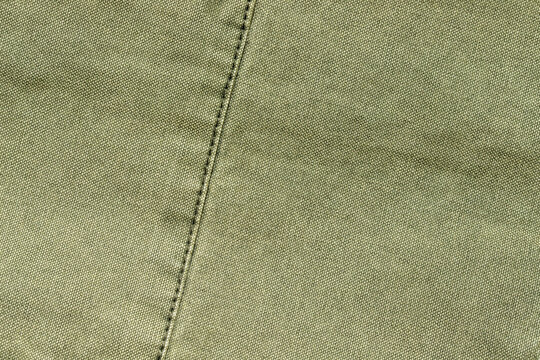 olive green canvas fabric texture background with stitched seam detail