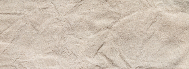 crumpled beige linen fabric texture background with natural linen material