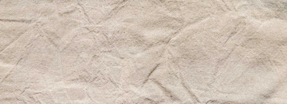 crumpled beige linen fabric texture background with natural linen material