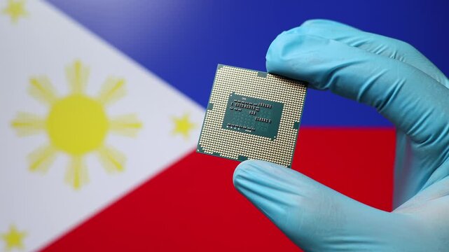 Close up view of hand in blue glove holding CPU microchip. Filipino flag in blurred background. Concept of semiconductor shortage and artificial intelligence development in Philippines.