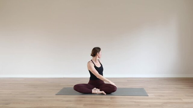 Woman practicing yoga in a modern yoga studio, focusing on balance, flexibility, mindfulness and relaxation in a peaceful wellness environment