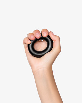 Hand Exercising with Grip Ring on Neutral Background